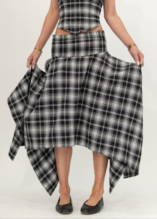 Mila Skirt in black and white plaid, front view showing the fitted hip yoke and asymmetric handkerchief hem, styled with the matching Alba Plaid top